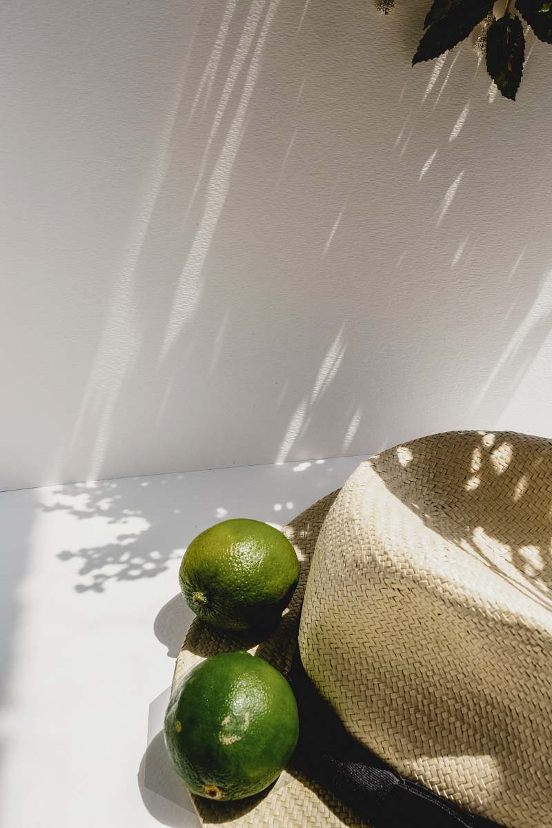 Discover the refreshing allure of citrus fruits showcased in this captivating scene. Featuring two ripe guavas nestled beside a vibrant lime and a chic hat, this image embodies a lively summer ambiance. Perfect for culinary blogs, lifestyle magazines, or any creative project focused on freshness and zest. Let this delightful composition inspire your designs and evoke a sense of tropical joy.